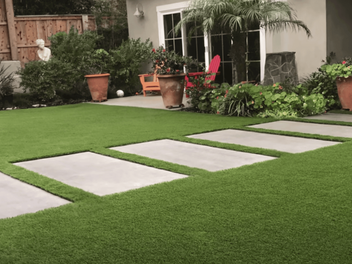 artificial lawn backyard with concrete pavers